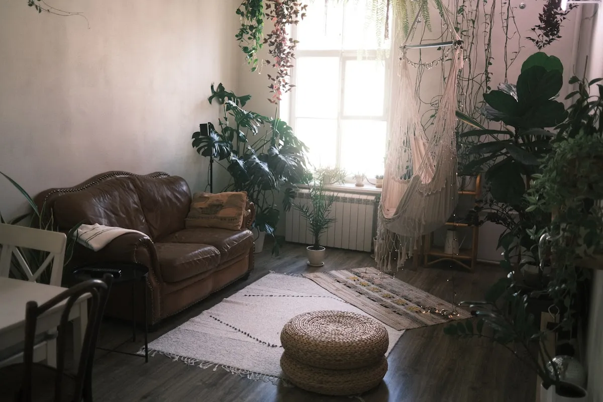 A living room full of furniture and plants, as photographed
